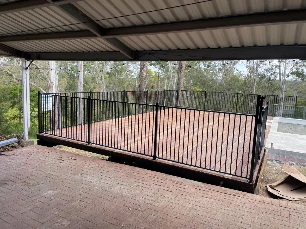 Black aluminium pool fence around a raised timber deck